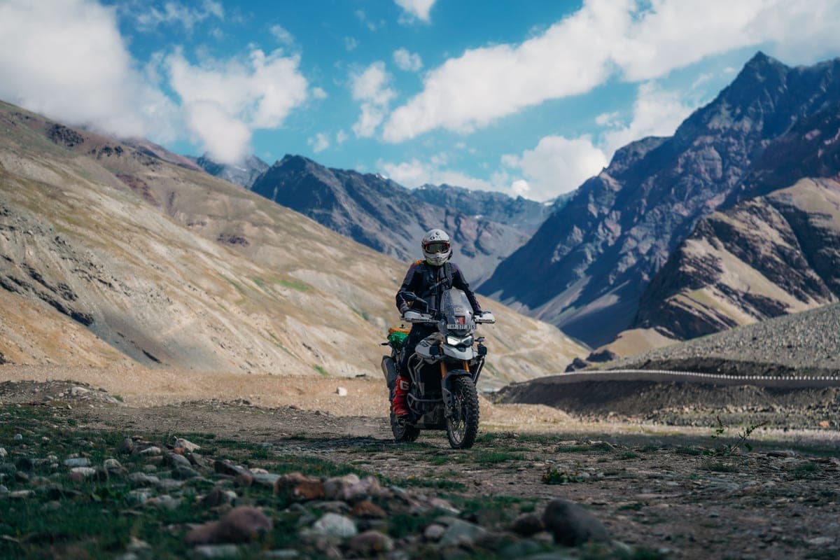 A motorcyclist in full touring gear on an open road